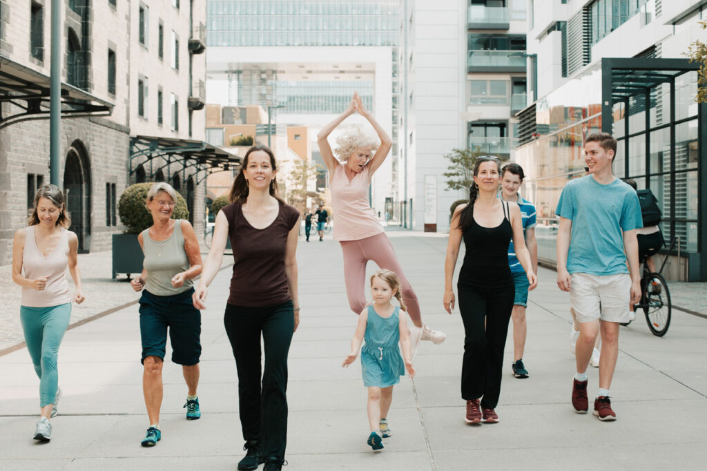 Photo of community walking down the street together in summer